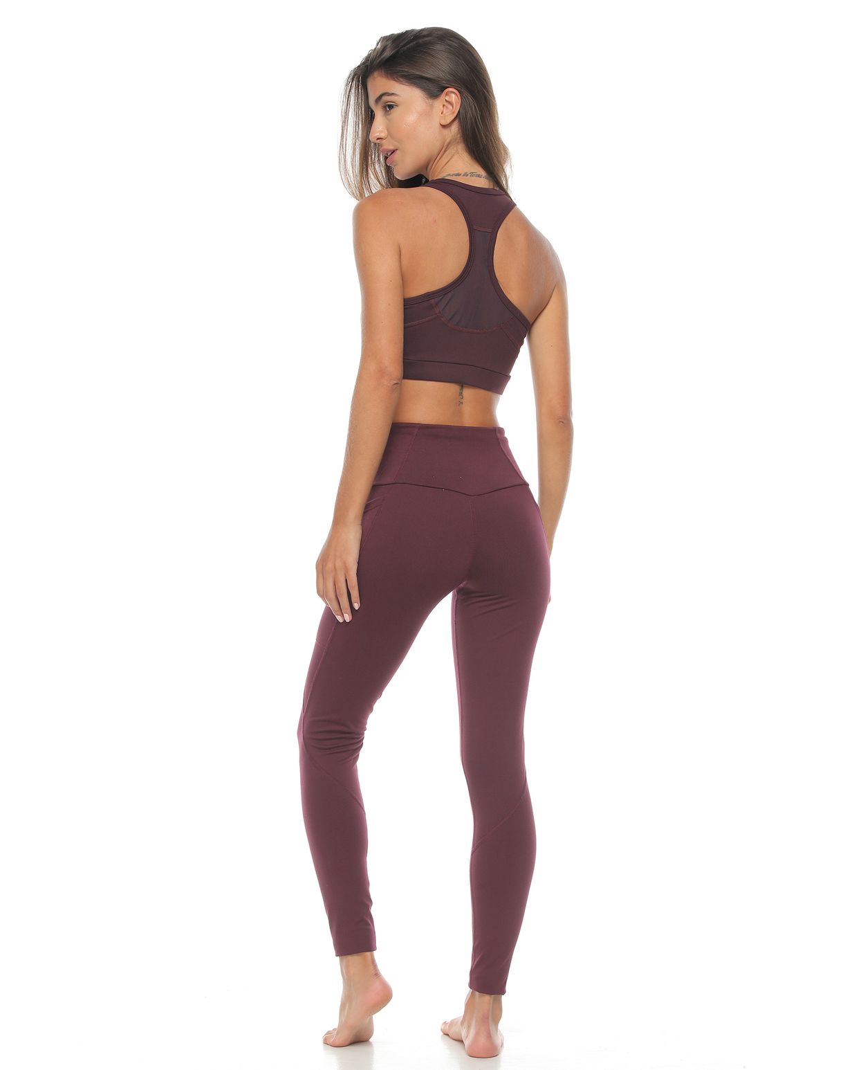 modelo con top y licra deportiva color berenjena para mujer cuerpo completo parte trasera